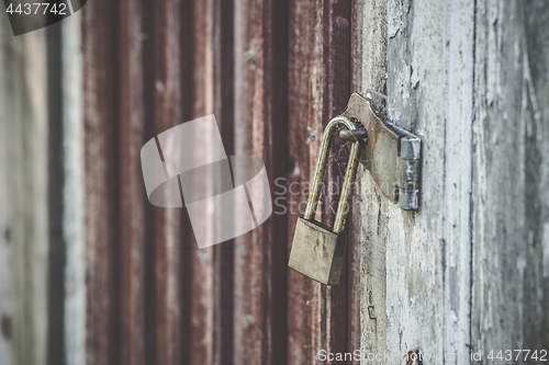 Image of Old lock on a wooden door in golden color