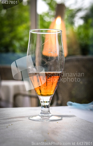 Image of Half of a glass of beer on a table