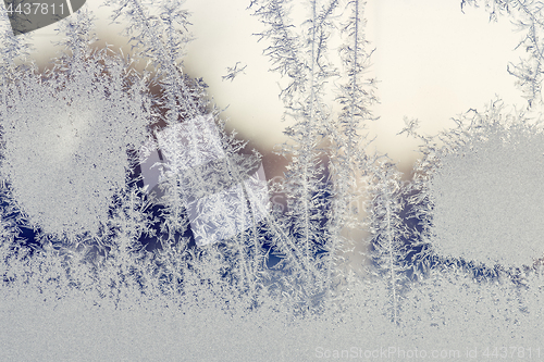 Image of Sunrise behind a window with frost patterns