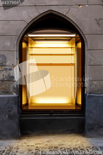 Image of illuminated shopwindow in retro building