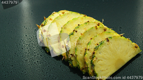 Image of Slices of fresh pineapples in row