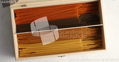 Image of Multicolored spaghetti in wood box