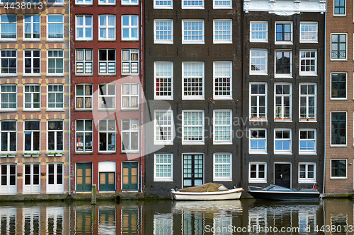 Image of Amsterdam canal Damrak with houses, Netherlands