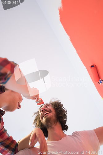 Image of couple painting interior wall