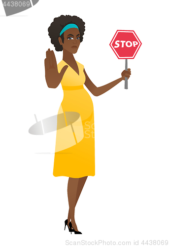 Image of African pregnant woman holding stop road sign.