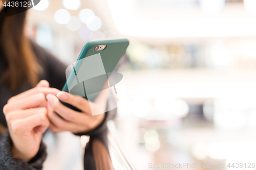 Image of Woman sending sms on cellphone