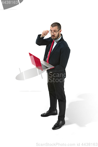 Image of Picture of handsome young bearded man standing over white studio background with laptop