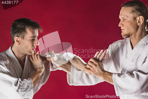 Image of Two men fighting at Aikido training in martial arts school