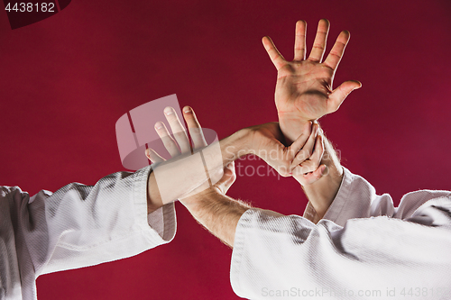 Image of Two men fighting at Aikido training in martial arts school