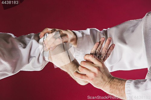 Image of Two men fighting at Aikido training in martial arts school