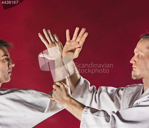 Image of Two men fighting at Aikido training in martial arts school