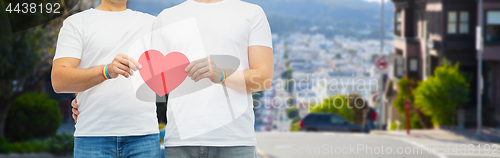 Image of couple with gay pride rainbow wristbands and heart