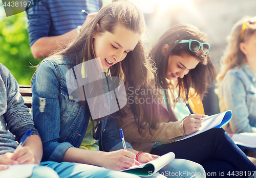 Image of group of students with notebooks at school yard