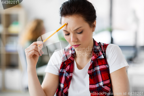 Image of creative woman with pencil thinking at office