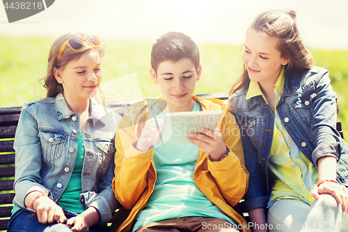 Image of happy friends with tablet pc computer outdoors