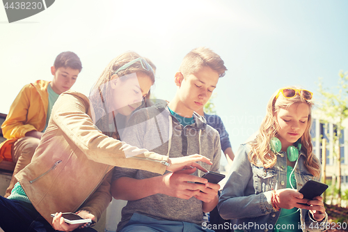 Image of teenage friends with smartphone and headphones