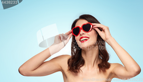 Image of woman with red lipstick and heart shaped shades