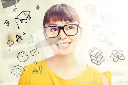 Image of happy asian young woman in glasses at home