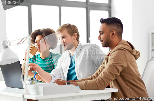 Image of happy creative workers with laptops at office