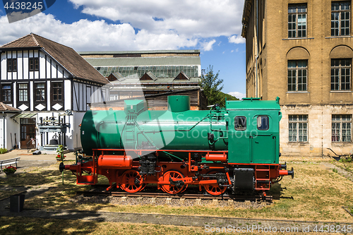 Image of Green and red locomotive on tracks