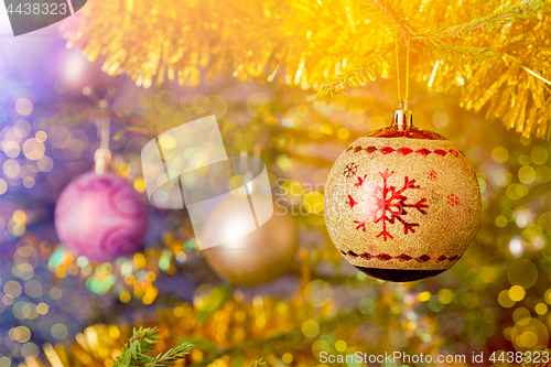 Image of Christmas-tree decoration bauble on decorated Christmas tree bac