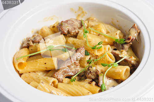 Image of penne pasta with veal meat