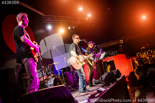 Image of Band performs on stage in a nightclub