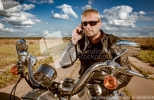 Image of Biker talking on a smartphone.