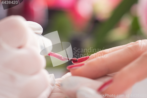 Image of Woman hands receiving a manicure