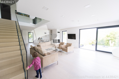 Image of family with little girl enjoys in the modern living room