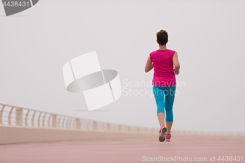 Image of woman busy running on the promenade