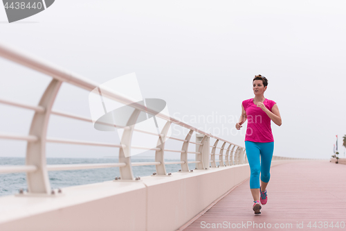 Image of woman busy running on the promenade