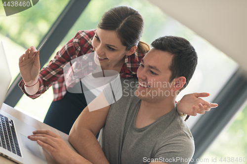 Image of happy young couple buying online