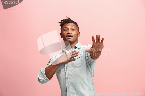 Image of Handsome man looking suprised isolated on pink