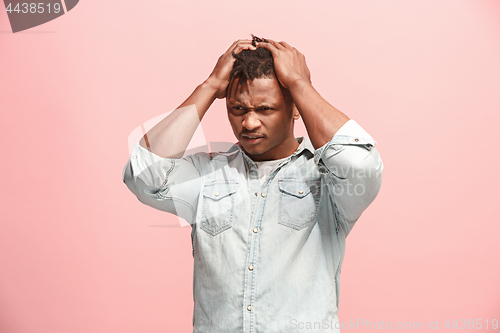 Image of African American Man having headache. Isolated over pink background.