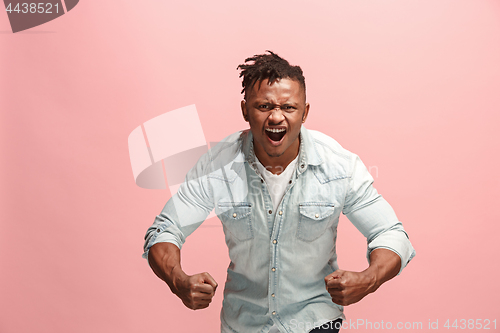 Image of The young emotional angry afro man screaming on pink studio background