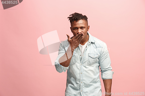 Image of Portrait of attractive Afro-American man with air kiss isolated over pink background