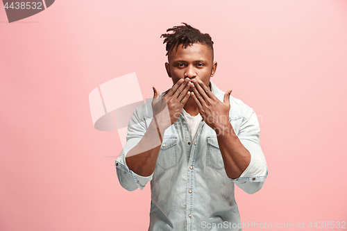 Image of Portrait of attractive Afro-American man with air kiss isolated over pink background
