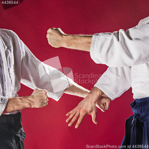 Image of Two men fighting at Aikido training in martial arts school