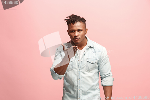 Image of Portrait of attractive Afro-American man with air kiss isolated over pink background