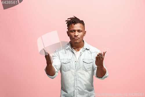 Image of Beautiful male half-length portrait isolated on pink studio backgroud. The young emotional surprised man