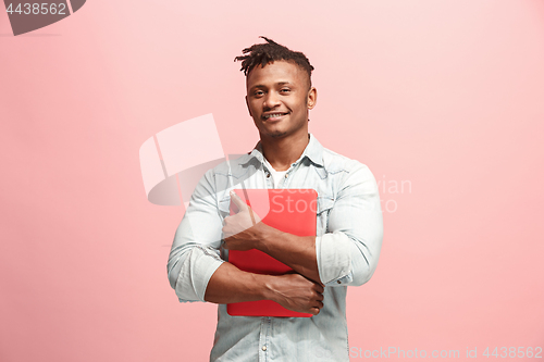 Image of Afro-American Businessman hugging laptop