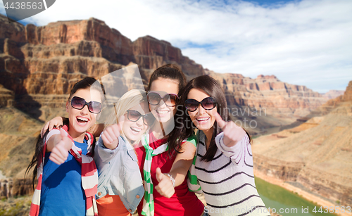 Image of teenage girls or young women showing thumbs up