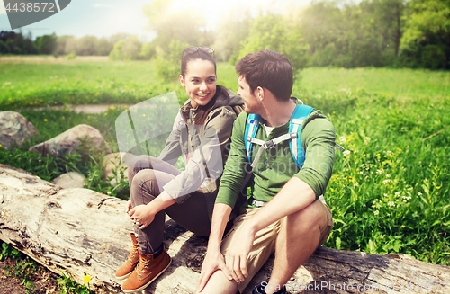 Image of smiling couple with backpacks in nature