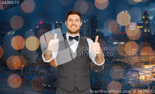 Image of happy man  showing thumbs up over singapore city