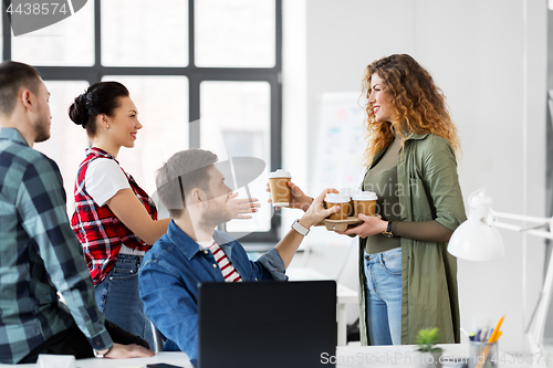 Image of happy creative team with coffee working at office