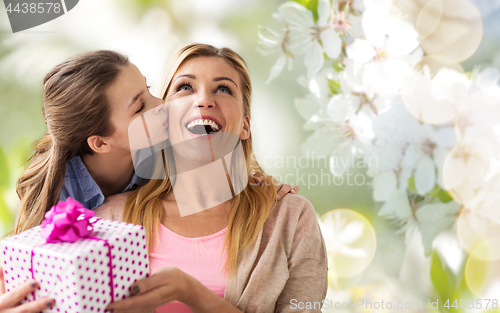 Image of daughter kissing mother and giving her present