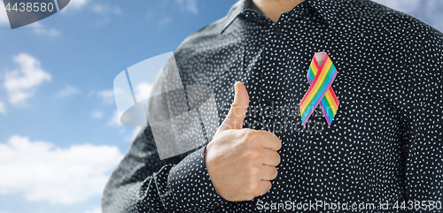 Image of man with gay pride rainbow awareness ribbon