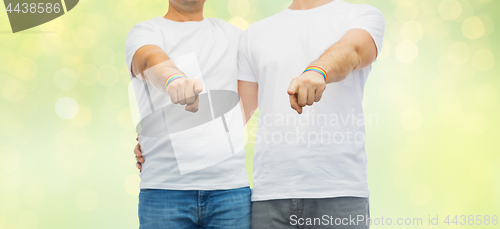 Image of couple with gay pride rainbow wristbands