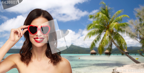 Image of woman with sunglasses over tropical beach